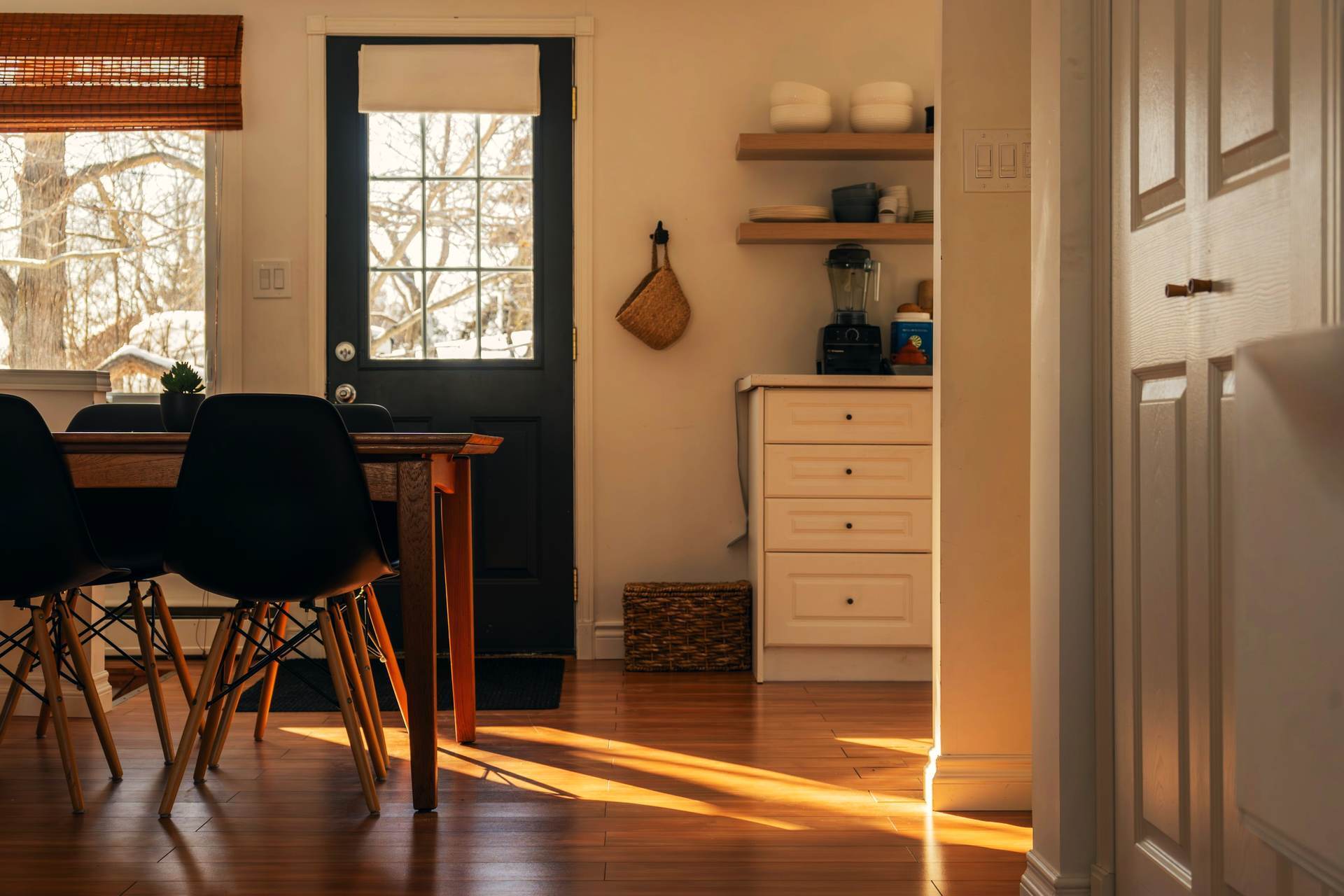 Morning light across a dining table in a warm home interior.