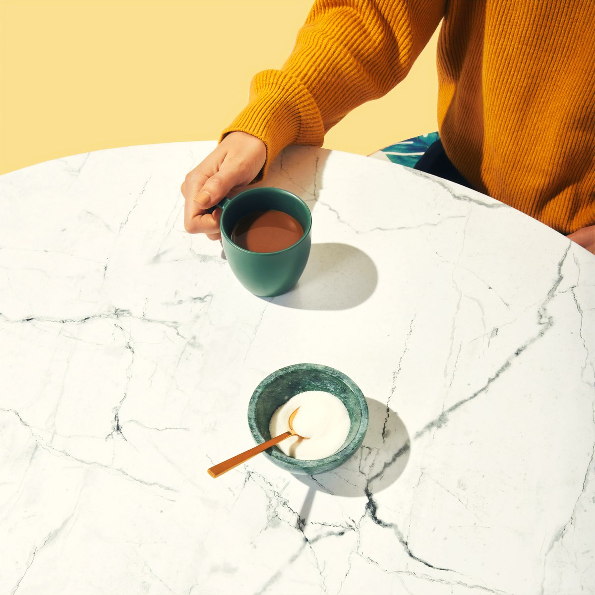 Two cups set down on a meeting table.